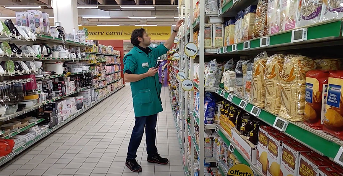 Store department head scanning shelf labels during field research